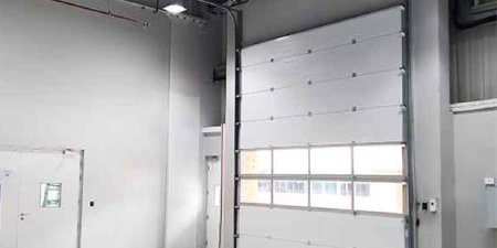 Sectional doors for retailer shipping and receiving bays