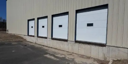 New York loading bay sectional overhead doors in Westchester County. Garage door installation for shipping and receiving facilities.